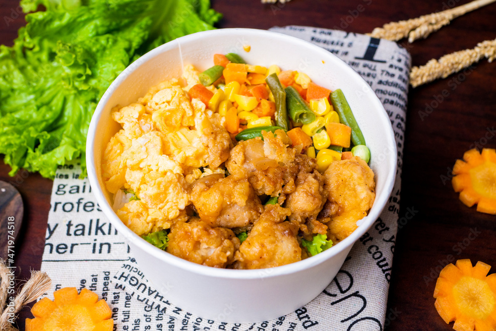 Indonesia style rice bowl, contain chicken katsu, egg, and vegetables Indonesia style rice bowl, contain chicken katsu, egg, and vegetables