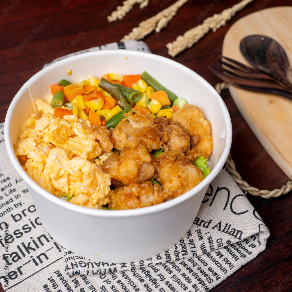 Indonesia style rice bowl, contain chicken katsu, egg, and vegetables Indonesia style rice bowl, contain chicken katsu, egg, and vegetables