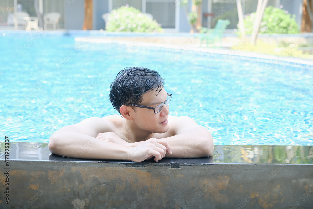 Asia man relaxation on swimming pool