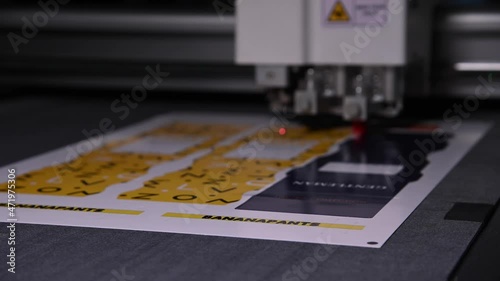 Close-up shallow depth of field a production plotter at a printing house automatically cuts packaging and labels from cardboard