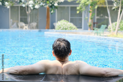 Asia man relaxation on swimming pool