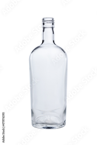 Empty bottle made of transparent, colorless glass for alcoholic beverages. Isolated on a white background, close-up
