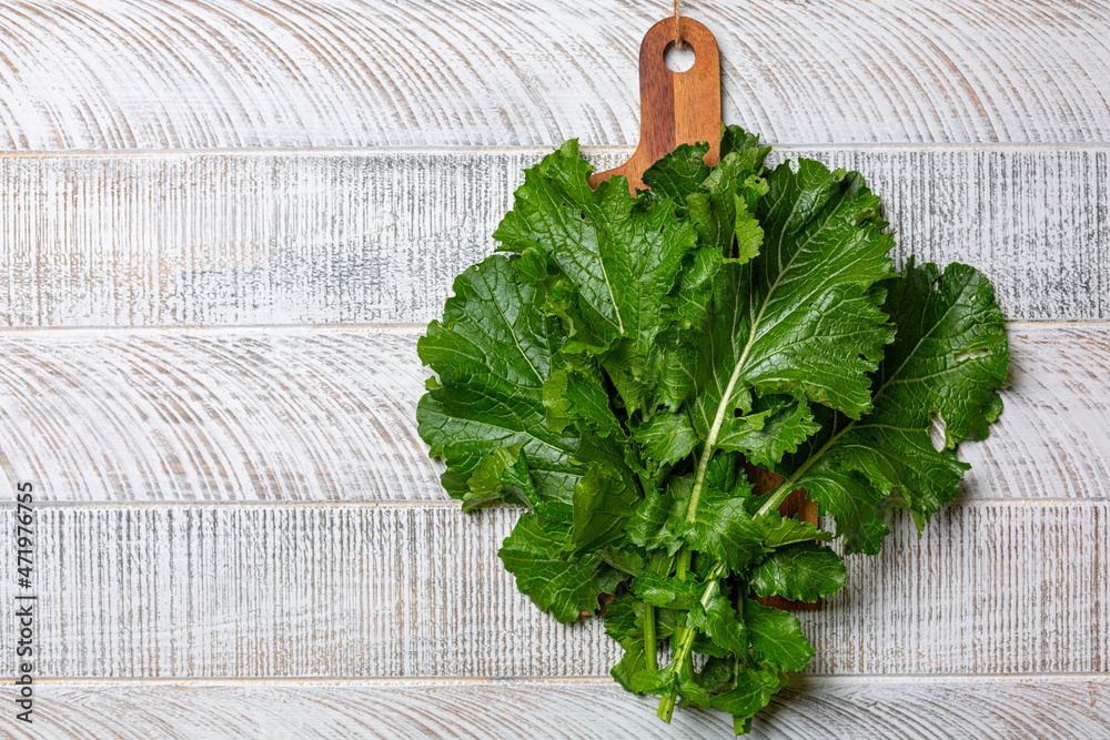 Turnip greens, the dark leafy edible green tops of turnips. They are