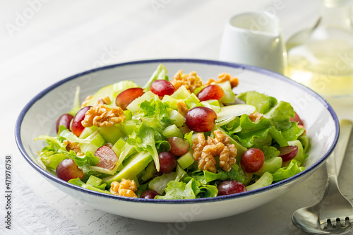 Waldorf salad, made of fresh apples, celery, walnuts, grapes, mayonnaise dressing, traditionally served on a bed of lettuce as an appetizer or a light meal.