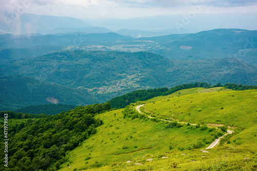 alpine carpathian scenery. view the hill of mountain runa in to the rural valley of turiya on a cloudy day. beautiful summer landscape