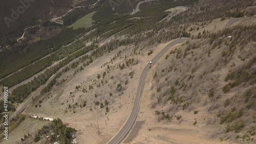 Mountain road switchbacks with cars from the air photo