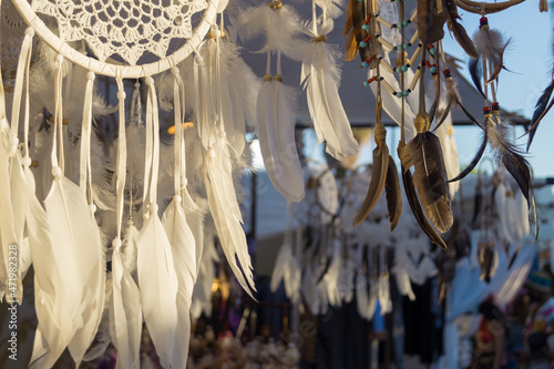 Amulet called dreamcatcher in a famous hippie market called Las Dalias in Sant Carles de Peralta in Ibiza (Balearic Islands, Spain). Handmade amulet  from the Native American Ojibwa Nation. photo