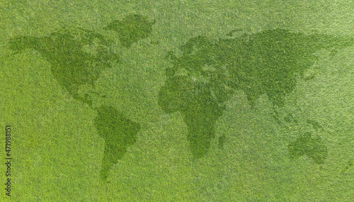 World map on green grass lawn background for global eco-friendly environment, ecological and environmental saving, earth day, and go green backdrop concept