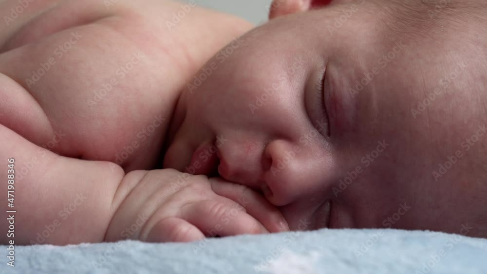 infancy, childhood, development, medicine and health, love, care concept - close-up face of newborn naked sleeping little small infant baby boy lying on stomach on soft blue banket on bed at home infancy, childhood, development, medicine and health, love, care concept - close-up face of newborn naked sleeping little small infant baby boy lying on stomach on soft blue banket on bed at home