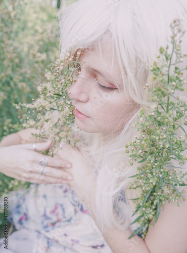 Artistic and reamy portrait of a woman surrouded by nature photo