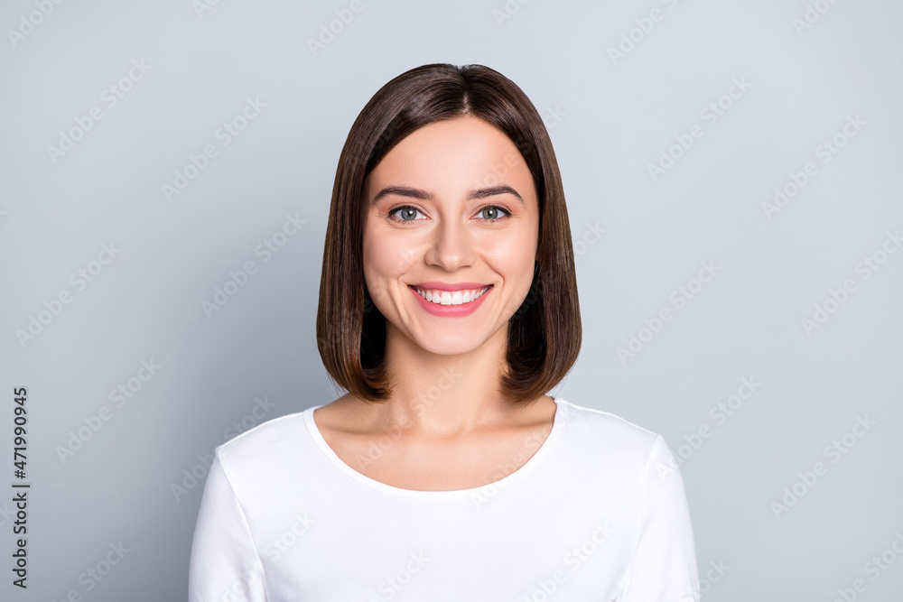 Photo of optimistic brunette millennial lady wear white shirt isolated on grey color background Photo of optimistic brunette millennial lady wear white shirt isolated on grey color background