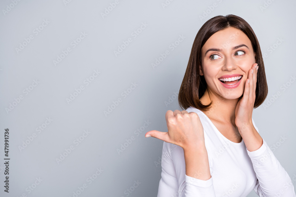 Profile photo of sweet brunette millenial lady indicate look empty space wear white pullover isolated on grey color background Profile photo of sweet brunette millenial lady indicate look empty space wear white pullover isolated on grey color background