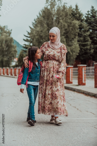 a Muslim mother returns from school with her daughter. Selective focus