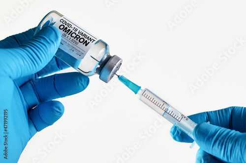 Doctor with syringe and vial of the dose vaccine for new Covid-19 Omicron B.1.1.529 virus. vaccination for booster shot for new Coronavirus Omicron in the population photo