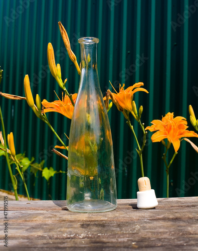 The bottle cap lies next to an empty alcohol bottle.