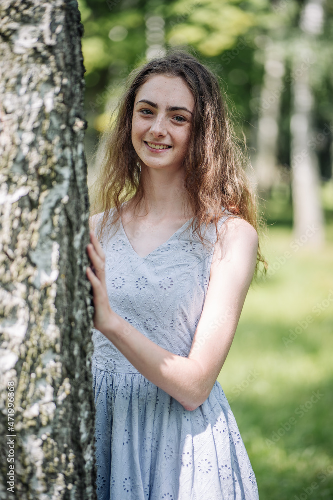 Portrait of a young smiling girl by a birch. Portrait of a young smiling girl by a birch.