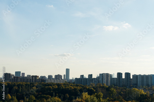 RUSSIA, MOSCOW: Scenic sunny day landscape view of the city garden with Ostankino tower and blue clouds in the background 