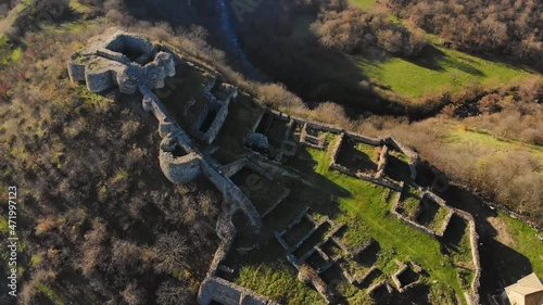 Rising aerial view Dmanisi archeological site ruins background. Famous hominins discovery site. Unesco world heritage center photo