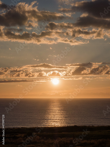 Sunrise view on the coast with the sun and clouds in the background