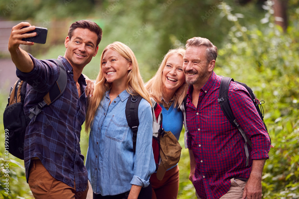 Group Of Friends Posing For Selfie In Countryside Taking Picture On Phone As They Hike Along Path Group Of Friends Posing For Selfie In Countryside Taking Picture On Phone As They Hike Along Path