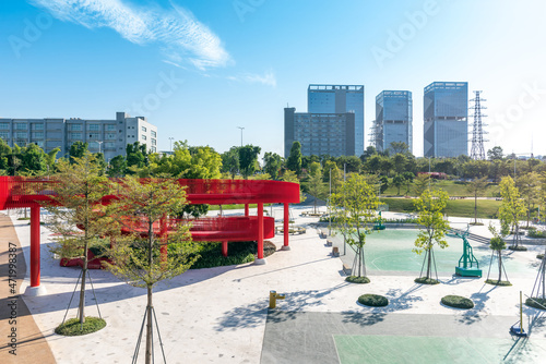 An outdoor park with a red bridge in Shenzhen, China photo