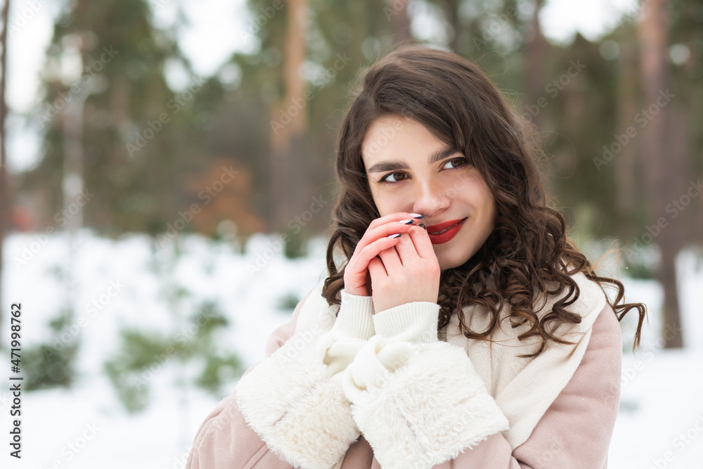 Charming young lady walking at the winter forest Charming young lady walking at the winter forest