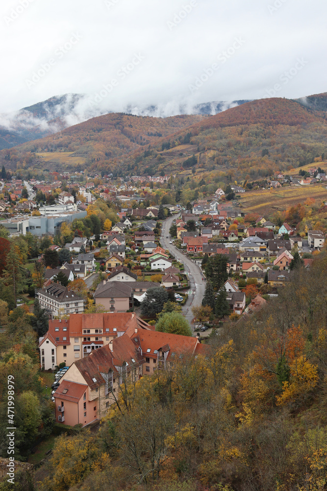 Autumnal aerial view of the historic town of Kaysersberg in the Alsace, France. View looking north west from the ramparts of Schlossberg Castle over the town to the Vosges mountains. Copyspace above.