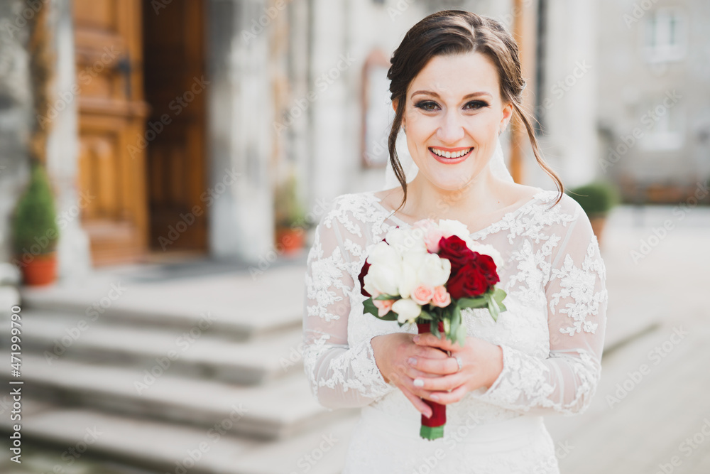 Bride holding big and beautiful wedding bouquet with flowers Bride holding big and beautiful wedding bouquet with flowers