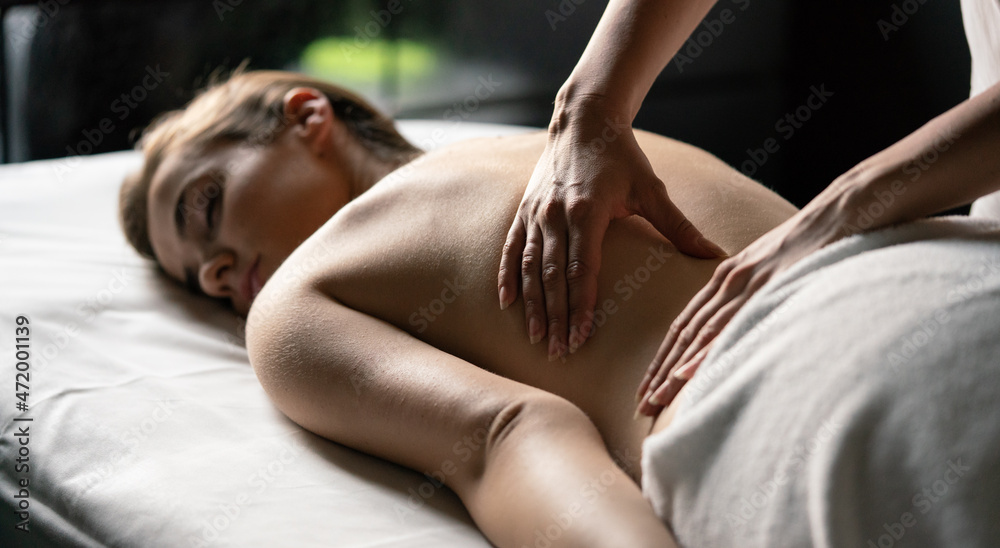 Obraz premium Attractive young healthy woman in spa salon having massage