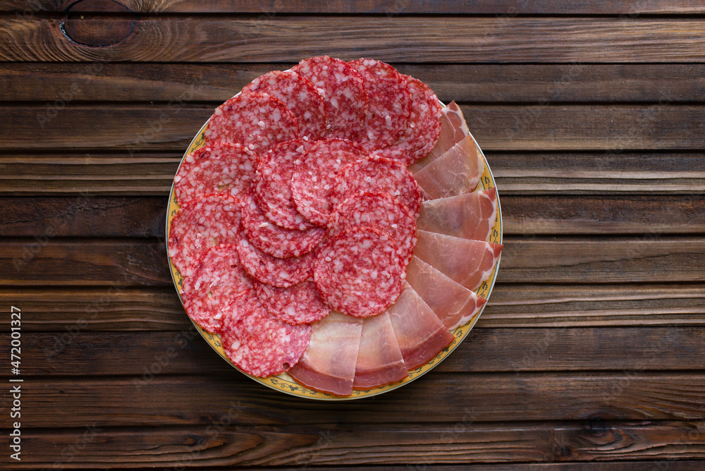 sliced ham and salami on wooden board sliced ham and salami on wooden board