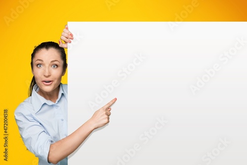 Promotion Billboard Concept. Cheerful woman Holding White Advertisement Board, Standing