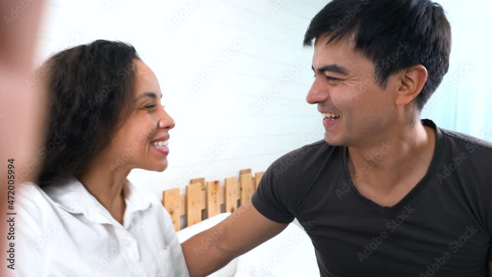 Lovely Hispanic couple making a video call, female holding smartphone talking and looking at the camera. Lovely Hispanic couple making a video call, female holding smartphone talking and looking at the camera.