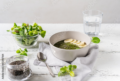 Green porridge in bawl with main ingredients
