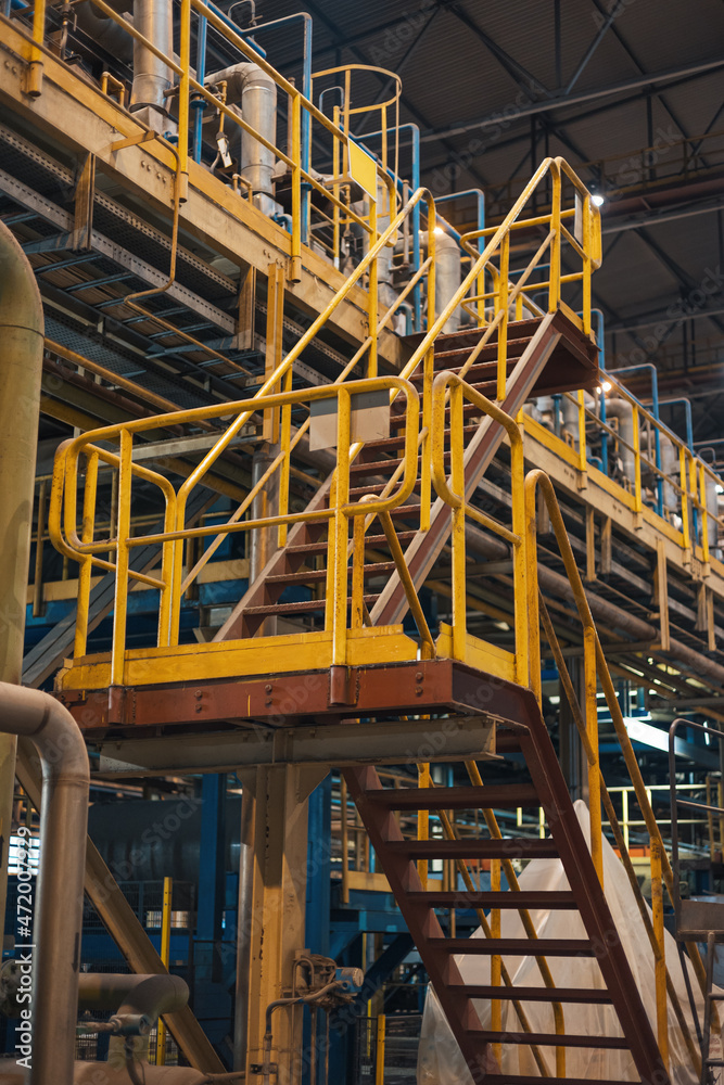 The handrail yellow stair for fire escape with the steel wall of the ...