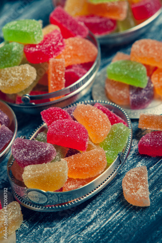 Dessert marmalade in the form of lemon and orange slices. The sweetness of jelly candy. photo