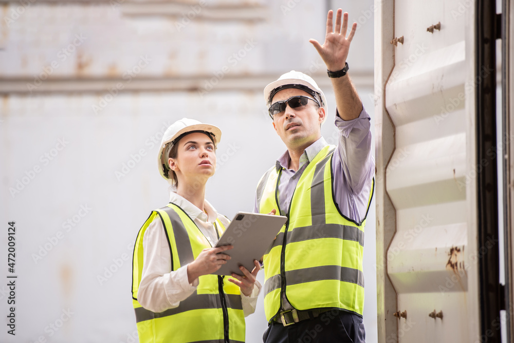 Caucasian man and woman staff. Inspector of Container at the port. Caucasian man and woman staff. Inspector of Container at the port.