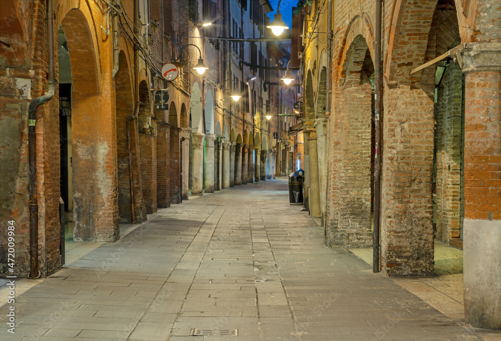 Ferrara - The street of old town at dusk.