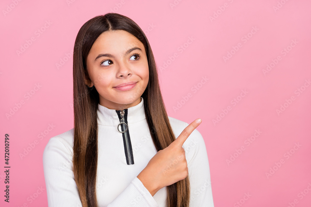 Photo of funky brunette teen girl indicate look empty space wear white pullover isolated on pastel pink color background Photo of funky brunette teen girl indicate look empty space wear white pullover isolated on pastel pink color background