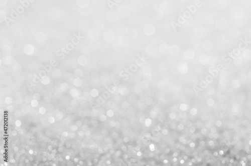 Abstract of Bright and sparkling bokeh background. silver and diamond dust bokeh blurred lighting from glitter texture