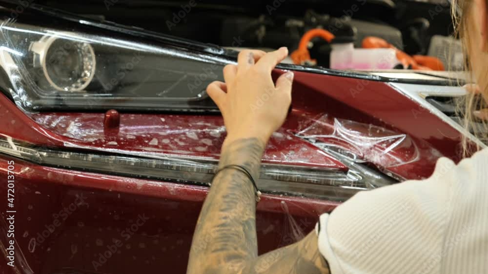 Video Stock Close up to PPF installation process on a front headlight