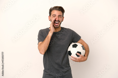 Young football player woman isolated on white background shouting with mouth wide open