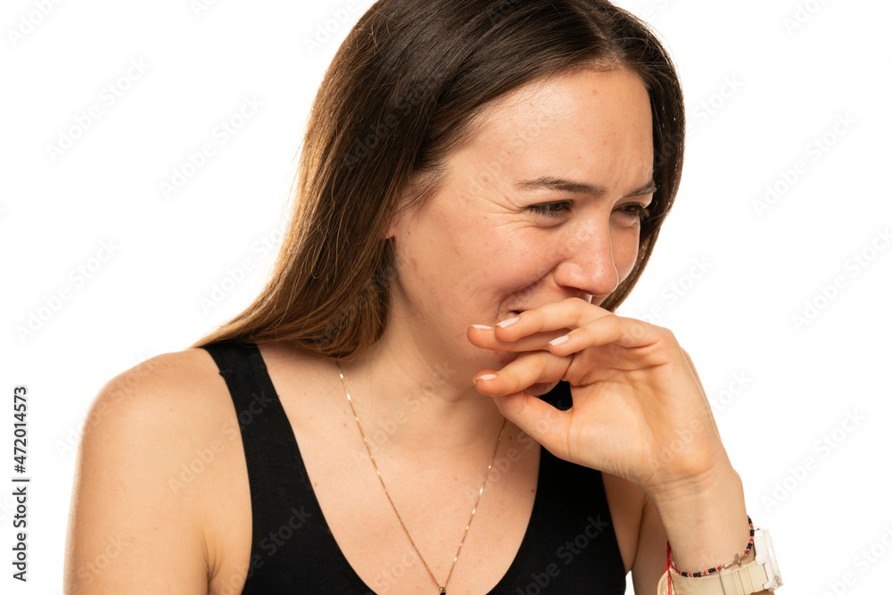 Fototapeta premium Woman laughing and covers her mouth with her hand