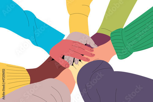 People with hands piled together. Multicultural friends of different colors and ethnicities cooperating. Equality concept.