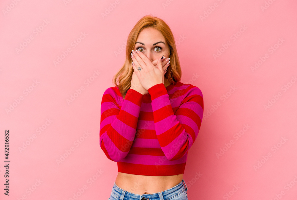 Young caucasian woman isolated on pink background covering mouth with hands looking worried. Young caucasian woman isolated on pink background covering mouth with hands looking worried.