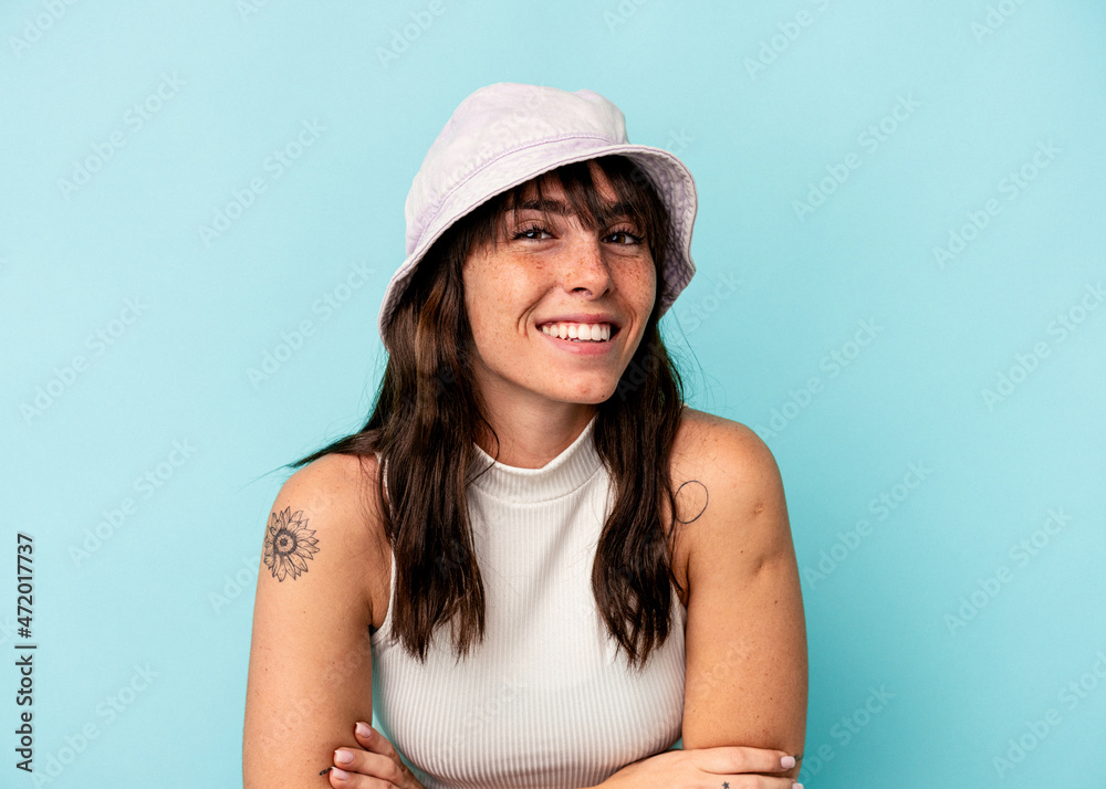 Young Argentinian woman isolated on blue background laughing and having fun. Young Argentinian woman isolated on blue background laughing and having fun.