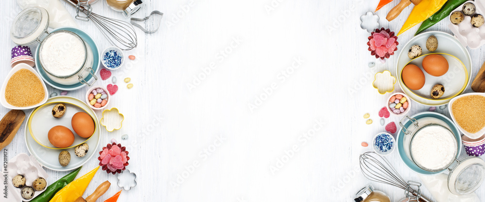 Cooking Easter background with rolling pin, eggs, whisk for whipping, cookie cutters, sugar sprinkling, flour. Rustic white wooden background, top view copy space. Cooking Easter background with rolling pin, eggs, whisk for whipping, cookie cutters, sugar sprinkling, flour. Rustic white wooden background, top view copy space.