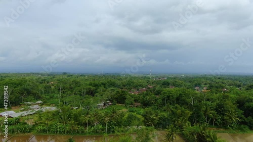 Sriwedari village on cloudy day, Muntilan in Indonesia. Aerial forward photo