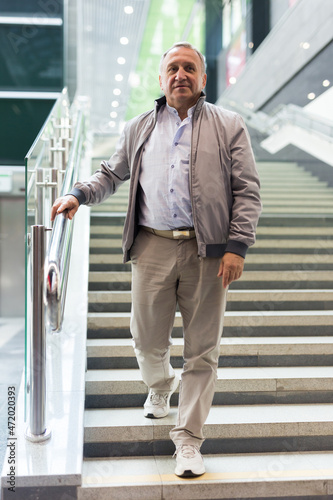 Mature man walking down the stairs to subway station