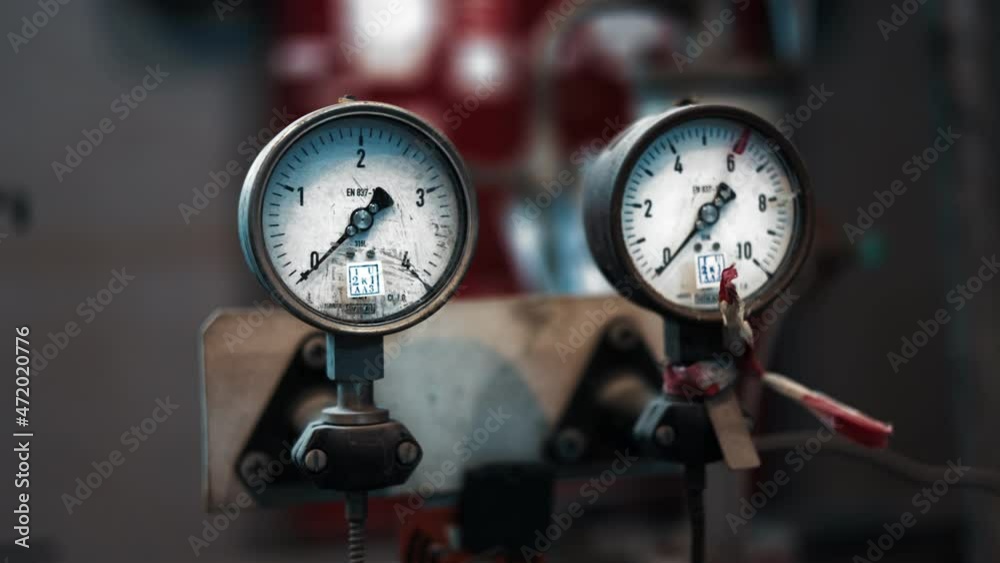 Dark surface with a deep reflection of pressure gauges.manometer in focus. A pressure gauge on the background of other instruments.