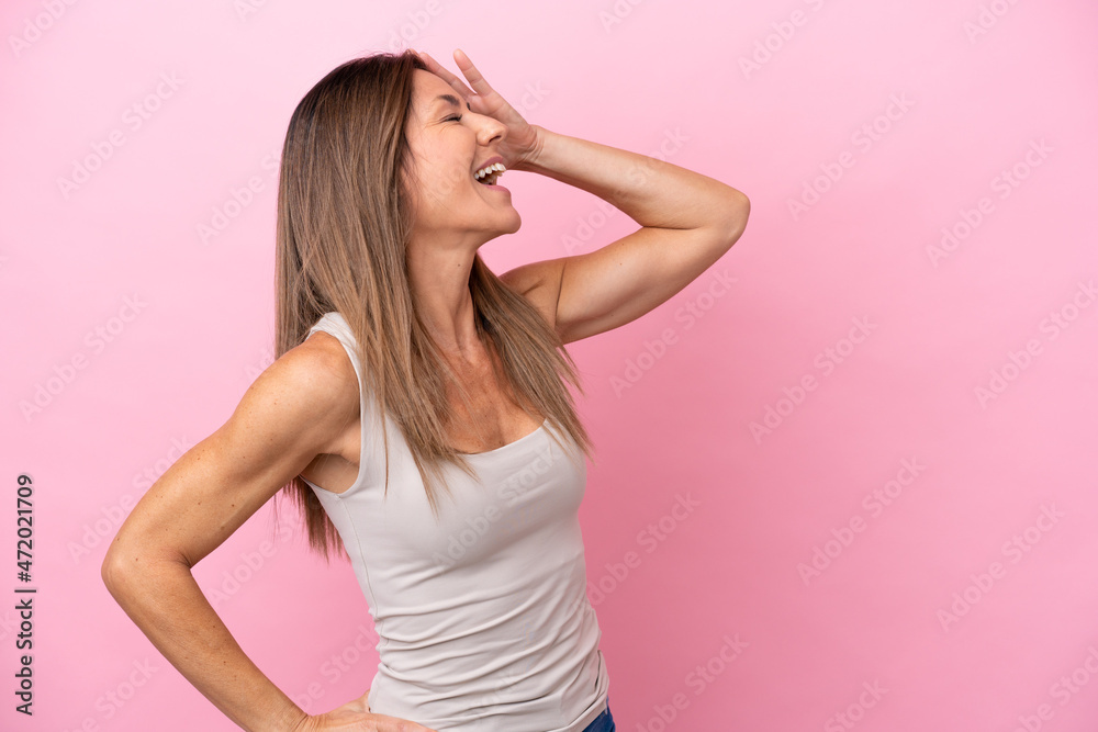 Middle age caucasian woman isolated on pink background smiling a lot Middle age caucasian woman isolated on pink background smiling a lot